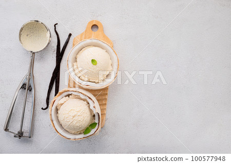 Coconut ice cream flavours in half of coconut setup on white stone background. Summer and Sweet menu concept. 100577948