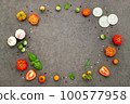 The ingredients for homemade pizza set up on dark stone background. 100577958