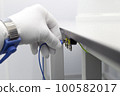 Bracelet on the hand of a man wearing ESD cloth and glove static resistance ESD bracelet or ground equipment, anti-static, used to safely ground is working. Semiconductor manufacturing. 100582017