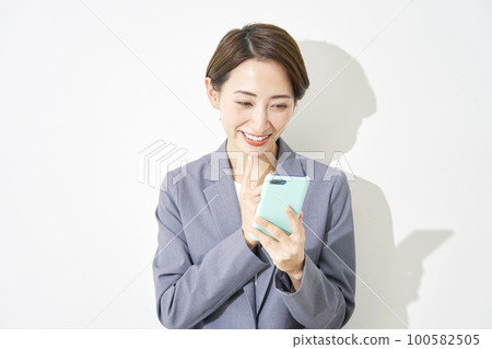 Business woman using smartphone White background Business woman using smartphone White background 100582505