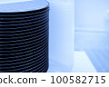 A batch of silicon wafers packed in a plastic storage box in the clean room of a semiconductor foundry ready for microchip production. 100582715