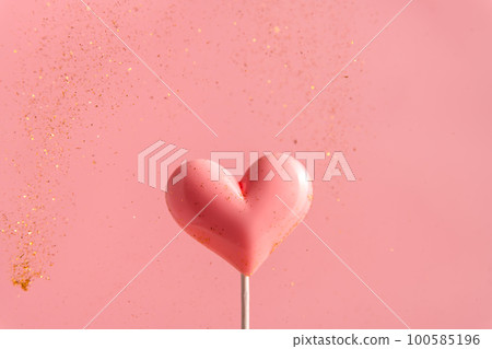 Pink Valentine's day heart shape lollipop candy on empty pastel paper background. Love Concept 100585196