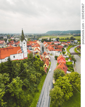 Vertical photo of old historical town with a church on a hill  100585967