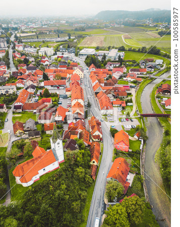 Vertical photo of an old town and a river trough the town on a cloudy autumn day 100585977