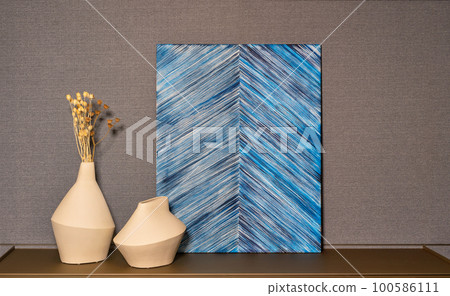 Minimalist decor interior with abstract painting and clay vases with dried flower stems. Minimalist decor interior with abstract painting and clay vases with dried flower stems. 100586111