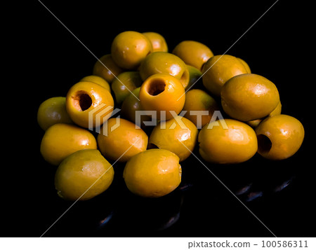 Fruits of green olives berries on a black background. 100586311
