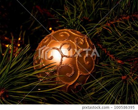 Glass ball of golden color on the Christmas tree. Glass ball of golden color on the Christmas tree. 100586395
