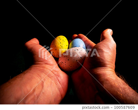 Easter chicken eggs in hand on a black background. Easter chicken eggs in hand on a black background. 100587609