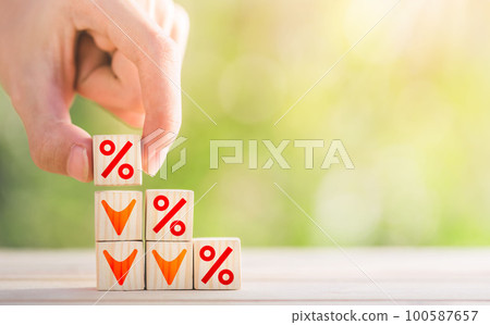 Hand arranged stacked wooden blocks for a step ladder with percentage sign and down arrow symbol. Mortgage rates business. Hand arranged stacked wooden blocks for a step ladder with percentage sign and down arrow symbol. Mortgage rates business. 100587657