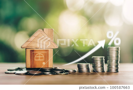 House is placed on the coins Stacked Coins on wooden table with white illustration shows increasing of interest rates increase. House is placed on the coins Stacked Coins on wooden table with white illustration shows increasing of interest rates increase. 100587663