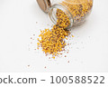 Yellow lentils and flaxseed mixed pour from the bottle 100588522