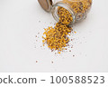 Yellow lentils and flaxseed mixed pour from the bottle 100588523