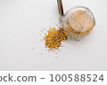 Yellow lentils and flaxseed mixed pour from the bottle 100588524