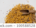 Wooden scoop with yellow lentils 100588528