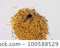Wooden scoop with yellow lentils 100588529