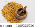 Wooden scoop with yellow lentils 100588530