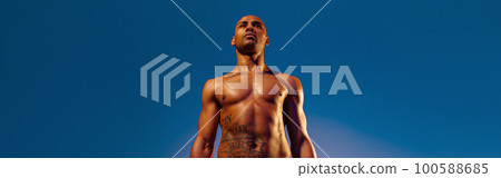 Muscular man doing exercise with weight dumbbells on studio background. Strength and motivation 100588685