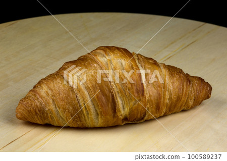 Croissant Bread Roll on a Circular Wooden Platter Croissant Bread Roll on a Circular Wooden Platter 100589237