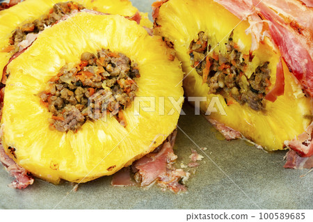 Pineapple stuffed with meat on a plate Pineapple stuffed with meat on a plate 100589685