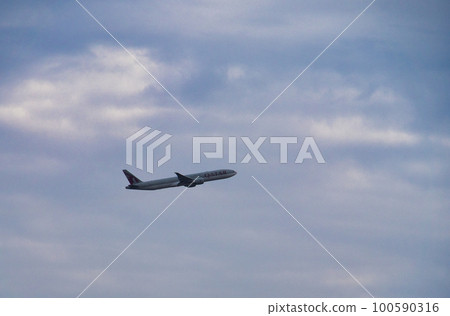 airplane in the sky. a passenger plane flies in the cloudy sky airplane in the sky. a passenger plane flies in the cloudy sky 100590316