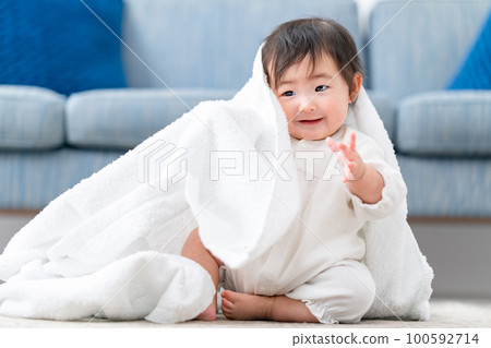 Baby playing with a towel Baby playing with a towel 100592714