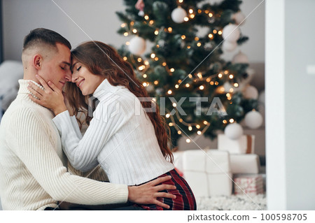 Closeness of the people. Young romantic couple celebrates New year together indoors Closeness of the people. Young romantic couple celebrates New year together indoors 100598705