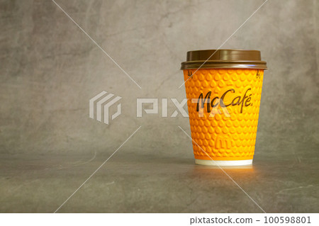 Paper cup of hot mcdonalds drink on stone table 100598801