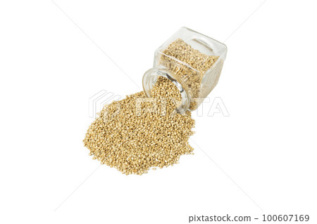 quinoa falling out of a glass jar isolated on white background. nutrition. food ingredient. 100607169