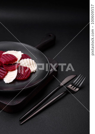 Delicious fresh mozzarella and boiled beets cut into slices Delicious fresh mozzarella and boiled beets cut into slices 100609557