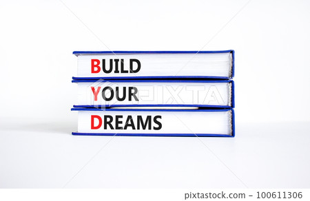 BYD build your dreams symbol. Concept words BYD build your dreams on books on a beautiful white table white background. Business and BYD build your dreams concept. Copy space. 100611306