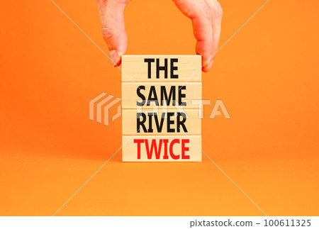 The same river twice symbol. Concept words The same river twice on wooden block. Beautiful orange table orange background. Motivational business the same river twice concept. Copy space. The same river twice symbol. Concept words The same river twice on wooden block. Beautiful orange table orange background. Motivational business the same river twice concept. Copy space. 100611325