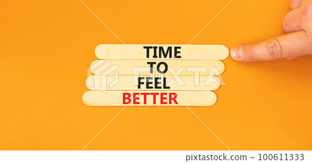 Time to feel better symbol. Concept words Time to feel better on wooden stick. Beautiful orange table orange background. Businessman hand. Motivational business time to feel better concept. Copy space 100611333