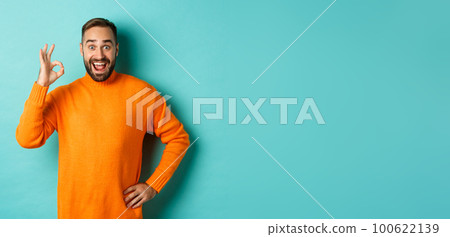 Impressed man recommending promo, showing okay sign and smiling amazed, approve and agree, standing over light blue background Impressed man recommending promo, showing okay sign and smiling amazed, approve and agree, standing over light blue background 100622139