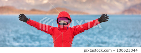 Adventurous young woman tourist happy to travel with open arms panoramic banner. Outdoor hike vacation active lifestyle people. 100623044