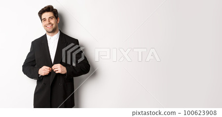 Image of handsome and confident businessman with beard, button down jacket and smiling, standing against white background 100623908