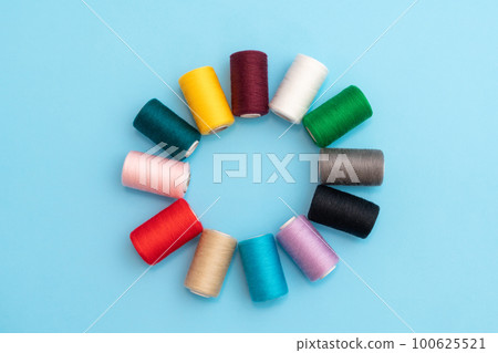 A circle in the form of a flower, colored spools with sewing threads as a concept of different people in one common business A circle in the form of a flower, colored spools with sewing threads as a concept of different people in one common business 100625521
