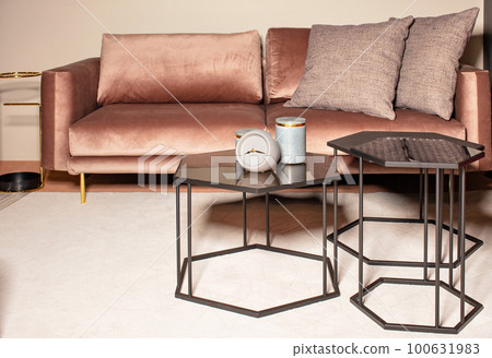 Loft-style metal coffee tables in the interior of the living room. 100631983
