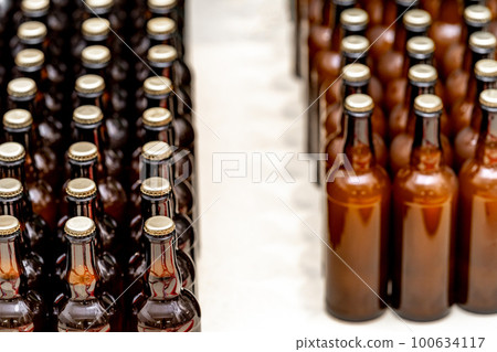 glass bottles with beer in the warehouse of the brewery glass bottles with beer in the warehouse of the brewery 100634117