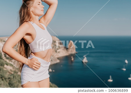 Woman summer travel sea. Happy tourist in hat enjoy taking picture outdoors for memories. Woman traveler posing on the beach at sea surrounded by volcanic mountains, sharing travel adventure journey Woman summer travel sea. Happy tourist in hat enjoy taking picture outdoors for memories. Woman traveler posing on the beach at sea surrounded by volcanic mountains, sharing travel adventure journey 100636899