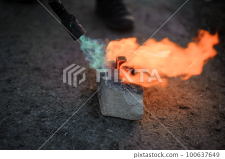 Coal on fire. Ignition of square coal with a gas burner on a stone 100637649