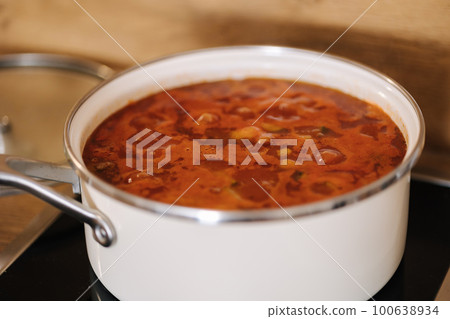 Mexican traditional dish is boiling in white pans. Home made food concept. Spicy food Mexican traditional dish is boiling in white pans. Home made food concept. Spicy food 100638934
