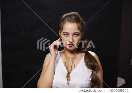 portrait shot of a young Ukrainian woman on the background, after make-up and hairstyle, for clothing advertising 100639441