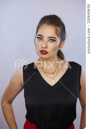 portrait shot of a young Ukrainian woman on the background, after make-up and hairstyle, for clothing advertising portrait shot of a young Ukrainian woman on the background, after make-up and hairstyle, for clothing advertising 100640636