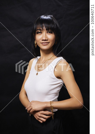 portrait shot of young happy asian or vietnamese woman, enjoying lifestyle, joy, happiness, photo on black background. portrait shot of young happy asian or vietnamese woman, enjoying lifestyle, joy, happiness, photo on black background. 100640711