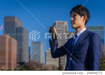 Young businessman taking off the mask 100646771