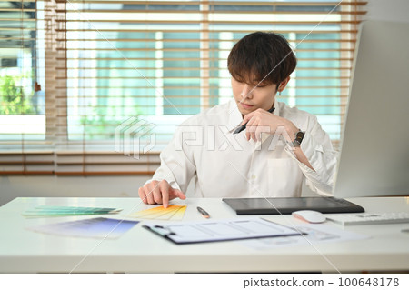Image of asian man designer developing a new app design and user interface at creative office 100648178