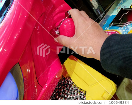 A hand holding a handle to play pachinko A hand holding a handle to play pachinko 100649284