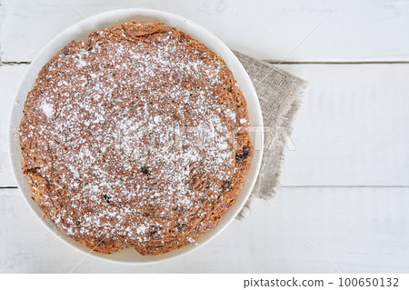 Carrot and raisin pie in a plate on a white table. Gluten-free pie without milk and without eggs. Selective focus, space for text. Dietary dessert. The concept of healthy eating. High quality photo Carrot and raisin pie in a plate on a white table. Gluten-free pie without milk and without eggs. Selective focus, space for text. Dietary dessert. The concept of healthy eating. High quality photo 100650132