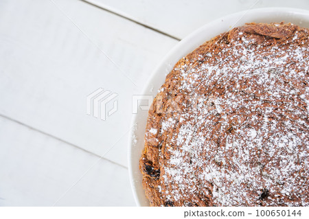 Top view of a piece of carrot and raisin pie. The pie is gluten-free, milk-free and egg-free. Selective focus, space for text. Diet dessert. The concept of healthy eating. High quality photo 100650144
