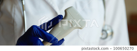 Doctor in white gown holding ultrasound probe 100650270